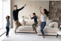 Happy family with two kids dancing in living room Royalty Free Stock Photo