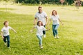 happy family with two kids having fun and running together