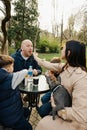 Happy family with two kids having a sancak at outdoor cafe on autumn day Royalty Free Stock Photo