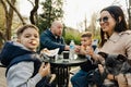 Happy family with two kids having a sancak at outdoor cafe on autumn day Royalty Free Stock Photo