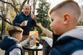 Happy family with two kids having a sancak at outdoor cafe on autumn day Royalty Free Stock Photo