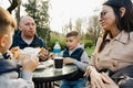 Happy family with two kids having a sancak at outdoor cafe on autumn day Royalty Free Stock Photo