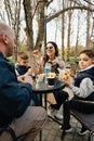 Happy family with two kids having a sancak at outdoor cafe on autumn day Royalty Free Stock Photo