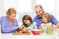 Happy family with two kids making dinner at home Royalty Free Stock Photo