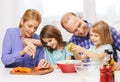 Happy family with two kids making dinner at home Royalty Free Stock Photo