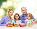 Happy family with two kids making dinner at home