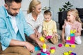 happy family with two kids playing with colorful blocks Royalty Free Stock Photo
