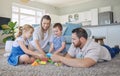 Happy family with two kids playing with colourful building blocks at home. Parents bonding with their two kids at home Royalty Free Stock Photo