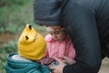 Happy family with two kids playing with drone in the field autumn time