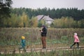 Happy family with two kids playing with drone in the field autumn time