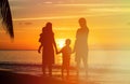 Happy family with two kids on sunset beach