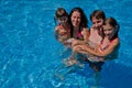 Happy family with two kids in swimming pool Royalty Free Stock Photo