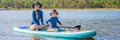 happy family of two, mother and son, enjoying stand up paddling during summer vacation BANNER, LONG FORMAT Royalty Free Stock Photo