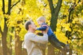 Happy family of two people laughing and playing in autumn wood Royalty Free Stock Photo