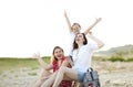 Happy family of two young women and little girl joyfully spending time together outside in nature Royalty Free Stock Photo