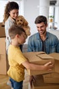 Happy family unpacking boxes in new home on moving day Royalty Free Stock Photo