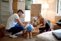 Family unpacking cardboard boxes in their new home Royalty Free Stock Photo