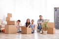 Happy family unpacking moving boxes at their home Royalty Free Stock Photo