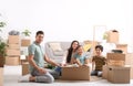 Happy family unpacking moving boxes at their home Royalty Free Stock Photo