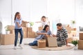 Happy family unpacking moving boxes at their home Royalty Free Stock Photo