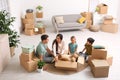 Happy family unpacking moving boxes at their home Royalty Free Stock Photo