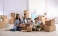 Happy family unpacking moving boxes at their home Royalty Free Stock Photo
