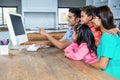 Happy family using computer in the kitchen Royalty Free Stock Photo