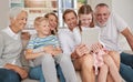 Happy family using a digital tablet in the living room at home. Cute little girl and boy bonding with parents and Royalty Free Stock Photo
