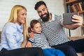 Happy family using digital tablet taking selfie at home Royalty Free Stock Photo