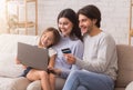 Happy Family Using Laptop And Credit Card For Online Shopping Royalty Free Stock Photo