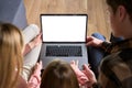 Happy family using laptop mock up screen sit on couch at home. Over shoulder Royalty Free Stock Photo