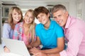 Happy family using laptop together Royalty Free Stock Photo