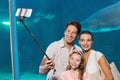 Happy family using selfie stick