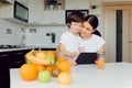 Happy family using a tablet pc in kitchen Royalty Free Stock Photo