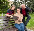 Happy family using tablet PC outdoors Royalty Free Stock Photo