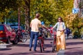 Happy family vacation on bikes in old streets in Amsterdam