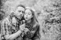 Happy family vacation. Father and little girl enjoy summertime. Dad and daughter blowing dandelion seeds. Keep allergies Royalty Free Stock Photo