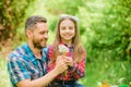 Happy family vacation. Father and little girl enjoy summertime. Dad and daughter collecting dandelion flowers. Keep Royalty Free Stock Photo