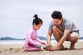 Happy family. Happy vacation holiday. Happy father and daughter are building a sandcastle on the tropical beach and have fun Royalty Free Stock Photo