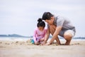 Happy family. Happy vacation holiday. Happy father and daughter are building a sandcastle on the tropical beach and have fun Royalty Free Stock Photo