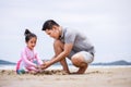 Happy family. Happy vacation holiday. Happy father and daughter are building a sandcastle on the tropical beach and have fun Royalty Free Stock Photo