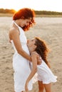 Happy family in vacation and travel. Mom hug tender her daughter outside at the sunset Royalty Free Stock Photo