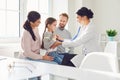 Happy family on a visit to the doctor in the office of a doctor.