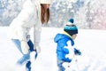 Happy family on the walk in sunny, snowy day - winter holidays