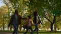 Happy family walking autumn park holding hands evening. Caring people together. Royalty Free Stock Photo