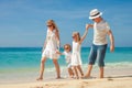 Happy family walking at the beach at the day time. Royalty Free Stock Photo