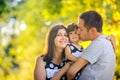 Family walking in beautiful autumn park at sunset Royalty Free Stock Photo