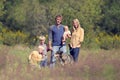 Happy Family Walking Dog In Autumn Royalty Free Stock Photo