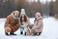Happy Family Walking Dog in Winter Royalty Free Stock Photo
