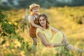 A Happy family walking history. mother and baby hugging in a meadow yellow flowers on nature in summer Royalty Free Stock Photo